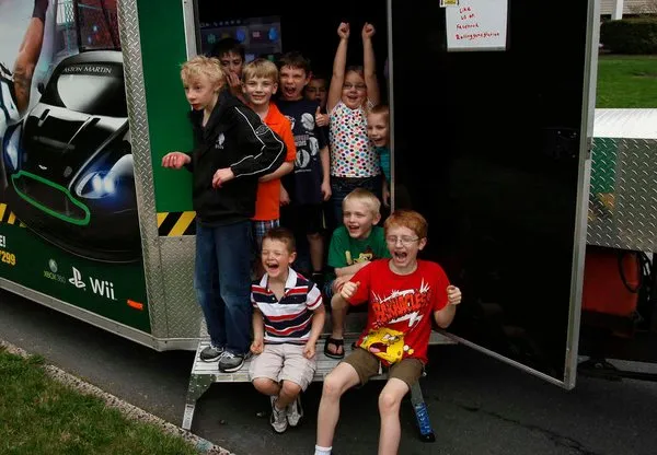 Kids celebrating at the back of the game truck