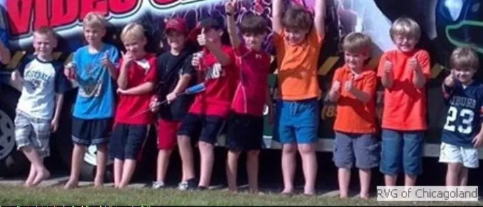 Kids posing outside the video game truck